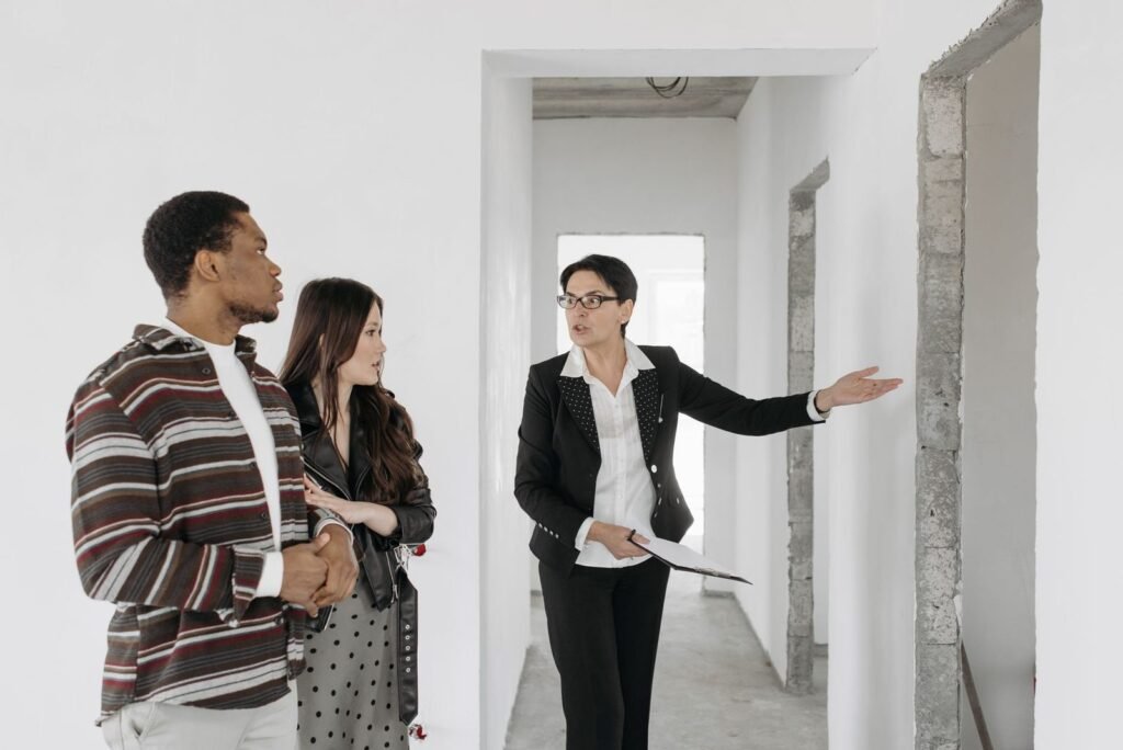 Pareja visitando un piso en venta acompañada de un agente inmobiliario
